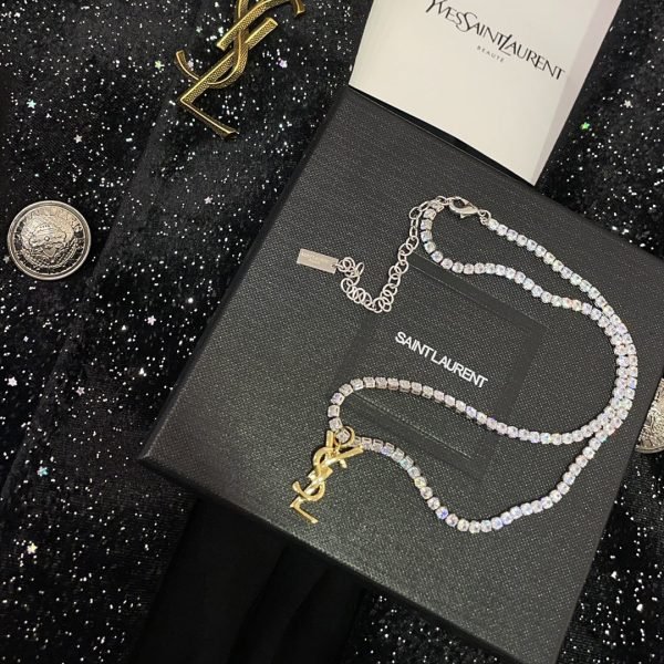 YSL letter brooch is a perfect match for a suit jacket